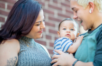 Two mothers with their baby