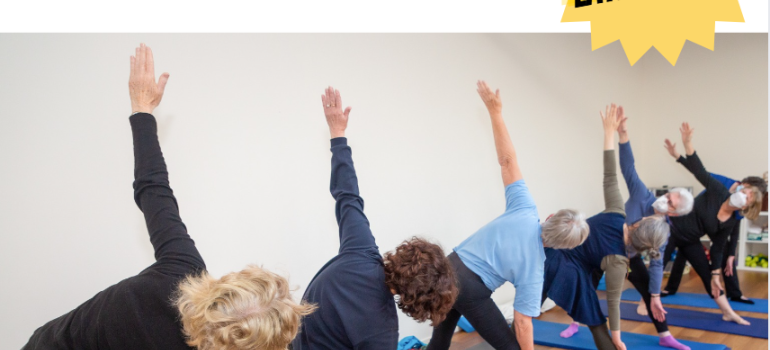 Six women doing yoga on blue mats. 