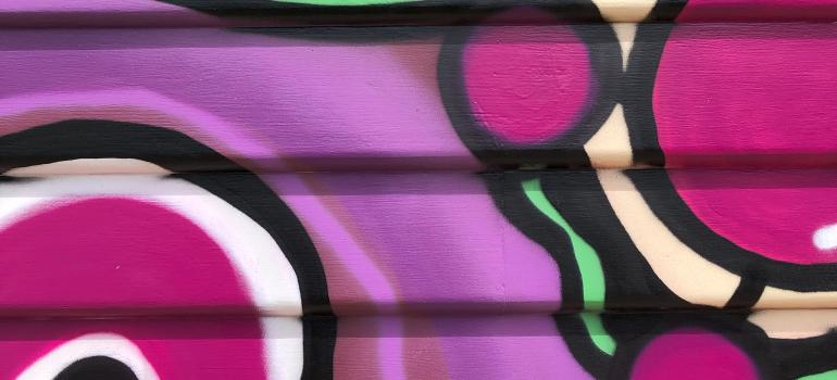 A small slice of the vibrant purple, yellow, green and blue shapes that make up the mural