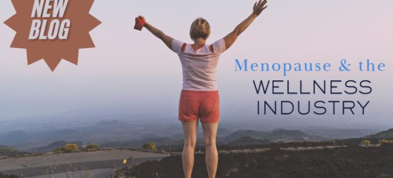 Woman with arms outstretched standing on top of a large hill