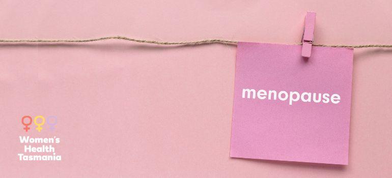 a pink sticky note with the word 'menopause', the WHT logo