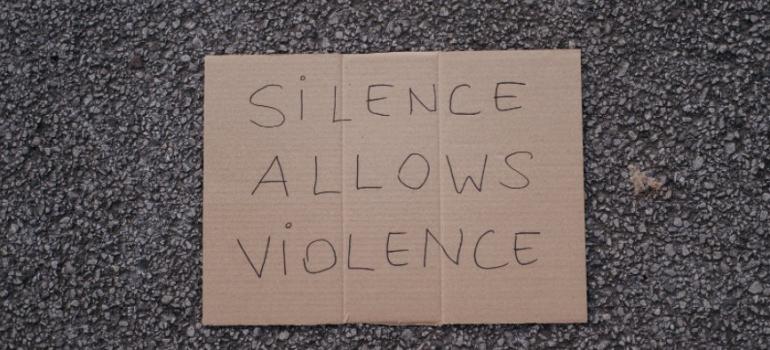 Sign says 'silence allows violence'